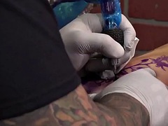 Alternative girls pussy is masturbated during a tattoo session
