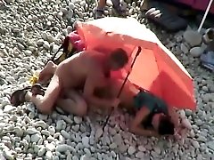 Nude beach pussy and ass eating under an umbrella